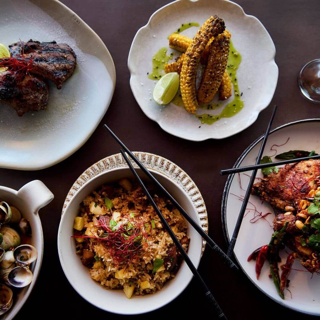 Plates of Asian food arranged on a table